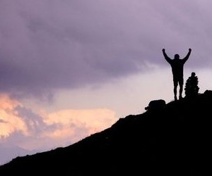 Victory silhouette, man on mountain